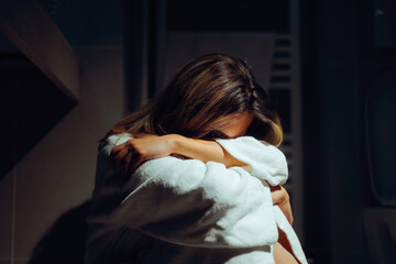 Sad Unhappy Girl Crying Alone in the Dark. Depressed woman feeling overwhelmed with bad emotions...