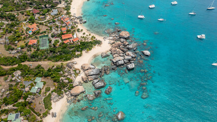 Paradise in BVI - Aerial shot of a luxury beach house with sailboats anchored in the front yard