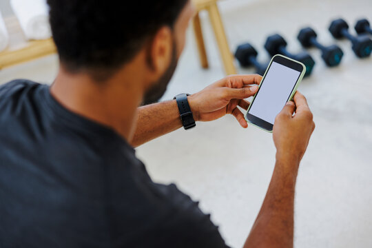 Man using smartphone in gym