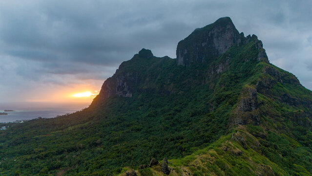 Aerial view captured by drone of a beautiful sunset behind Mount Otemanu on the tropical island Bora Bora in French Polynesia. 