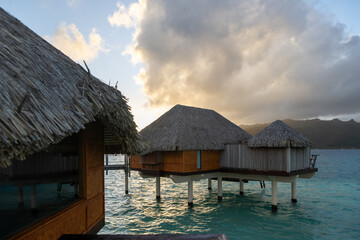 Overwater bungalow hut on a tropical island resort. The popular tourist accommodations are luxurious with a view of paradise. 