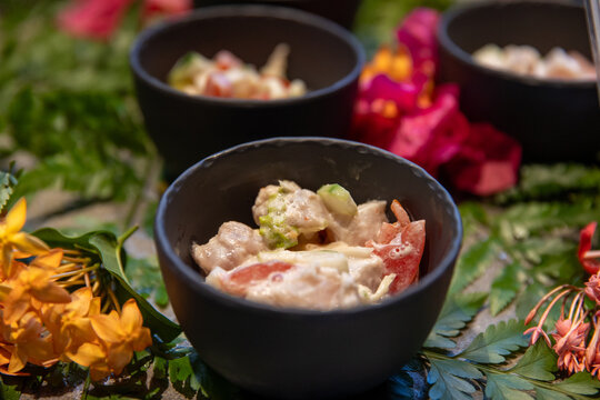 Poisson cru, a traditional raw fish salad in French Polynesia made with fresh, raw tuna, vegetables, lime juice, and coconut milk. It is the national dish of Tahiti similar to poke or ceviche/ 