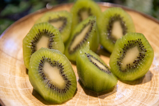Fresh tropical green kiwi fruit sliced and on a plate ready to eat for breakfast. 