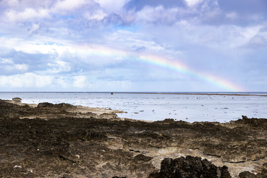 A colorful rainbow over the South Pacific ocean on tropical island of Taha'a near Bora Bora in French Polynesia. 