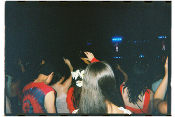 Concert attendees wearing red shot on 35mm film
