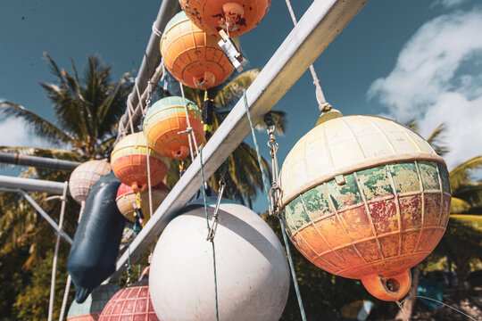 Sun faded colorful buoys for a boat hanging off a pier at tropical island Bora Bora in French Polynesia