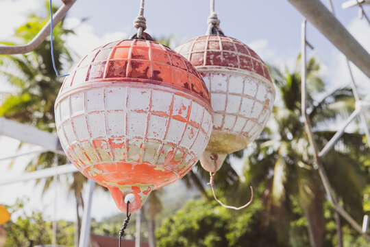 Sun faded colorful buoys for a boat hanging off a pier at tropical island Bora Bora in French Polynesia