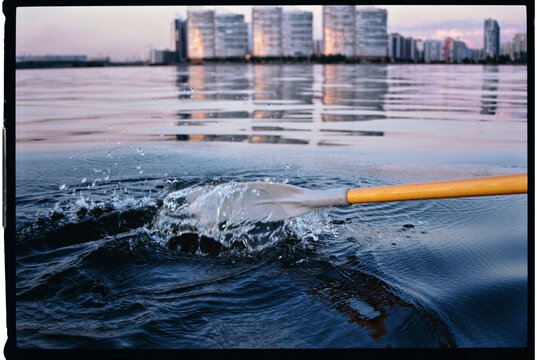 splash from an oar in a city lake
