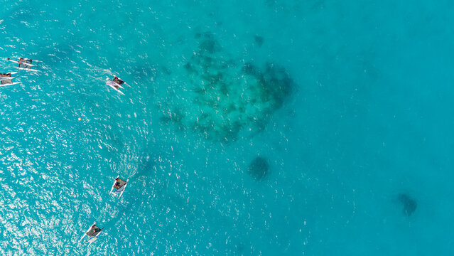 Aerial view of sailboats sailing over azure ocean south pacific sea water off the shore of Bora bora