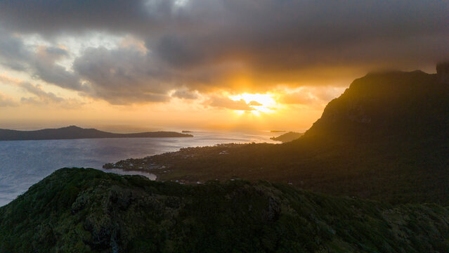 Sunset over Mount Otemanu on tropical island Bora Bora in French Polynesia. Low clouds float above the extinct volcano on the popular tourist destination in the south pacific sea. 
