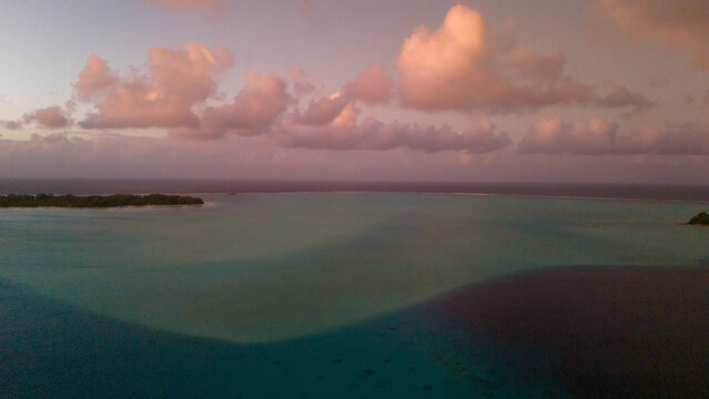 Sunset over Mount Otemanu on tropical island Bora Bora in French Polynesia. Low clouds float above the extinct volcano on the popular tourist destination in the south pacific sea. 