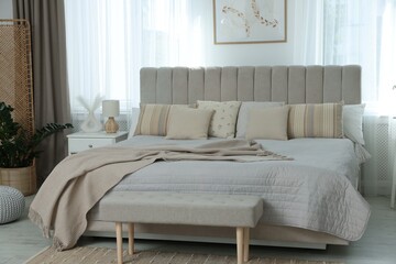 Big comfortable bed in room. Interior design
