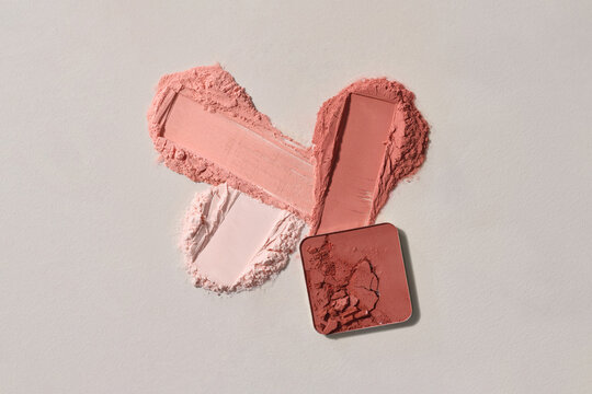 Crushed Makeup Powders on White Background in Various Shades