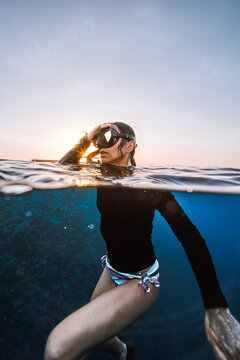 split shot portrait of female diver at sunset