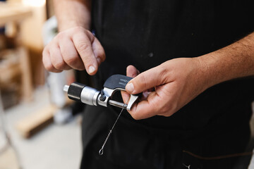 Technician Measuring Piano Wire