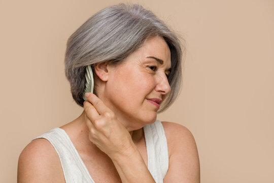 senior woman combing her gray hair