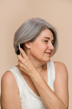 senior woman combing her gray hair