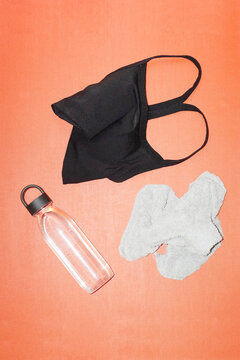 After sweat sport workout: sports bra, towel &  waterbottle on a floor