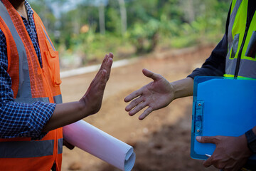 close up portrait of two construction workers disagreeing or disliking the concept of their work