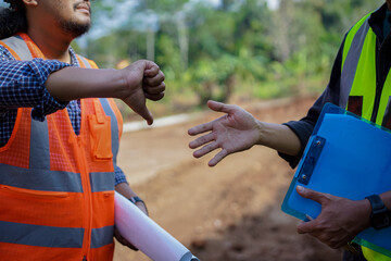 close up portrait of two construction workers disagreeing or disliking the concept of their work