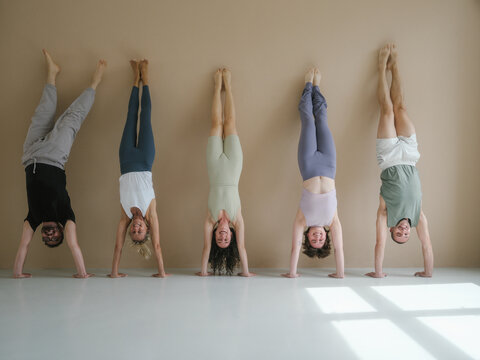 Five Smiling People in Handstand