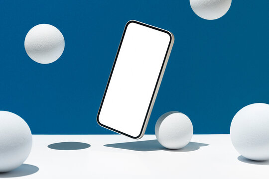 White screen telephone mockup and spheres, hovering on blue background
