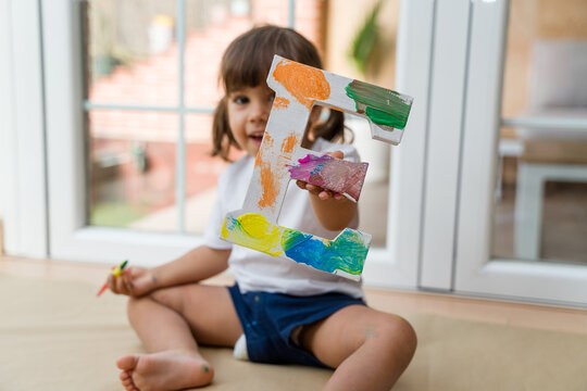 Cute girl playing and learning the alphabet at home