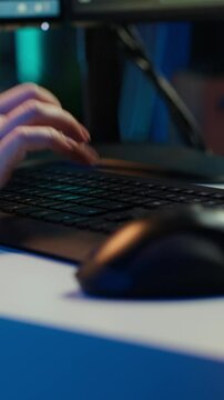 Vertical video Technician doing software quality assurance, reading source code on PC before implementing it. IT admin inspecting coding on computer, looking to fix potential issues, camera A close up