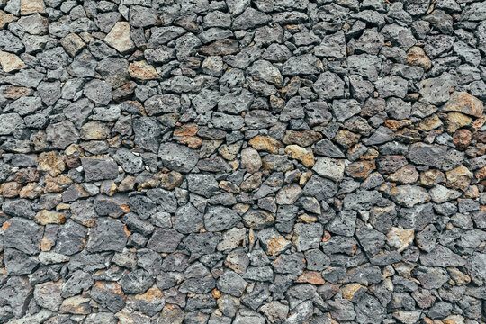 Volcanic stone wall with textured surface in natural setting