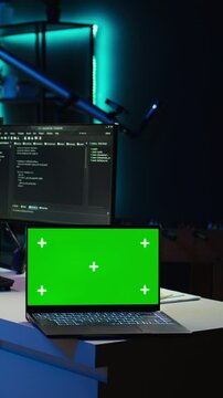 Vertical video Admin using green screen laptop to implement security measures, protecting company systems and data. IT worker testing and debugging code for software applications on chroma key