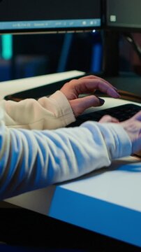 Vertical video Teleworking computer technician typing on keyboard, implementing security measures to protect company systems and data, close up. Remote IT employee at home debugging code for software