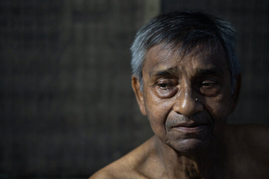 Aged man closeup portrait inside house
