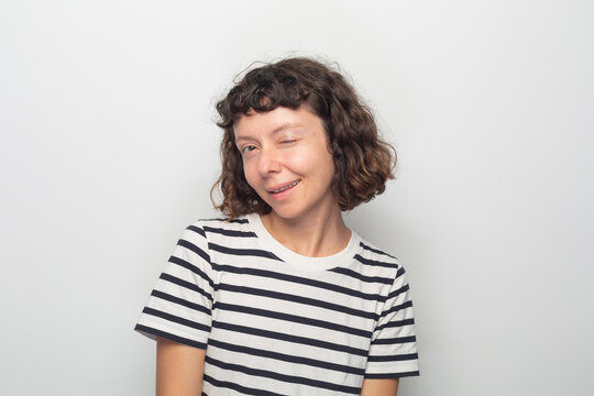 A young woman winking an eye