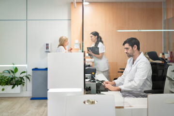 Medical staff working at hospital reception desk