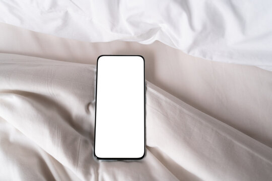 Blank screen Smartphone on a White Bed Sheet