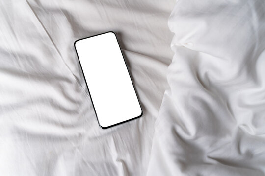 Blank screen Smartphone on a White Bed Sheet
