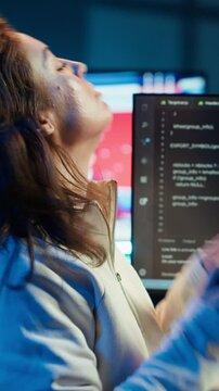 Vertical video Freelancing programmer listening music while designing and developing software applications. IT specialist wearing headphones, implementing and maintaining company systems, camera A