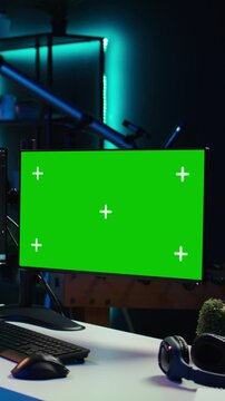 Vertical video Developer doing software debugging on green screen PC at home, checking lines of code displayed on monitors. IT professional in living room fixing coding problems on mockup computer