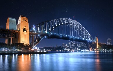 Obraz premium Harbour Bridge at Night: Illuminated Sydney Skyline with Reflections Background