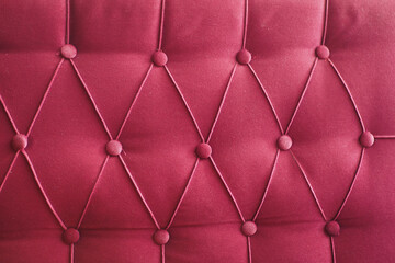 This is an elegant red upholstered fabric that features stylish buttontufted detailing