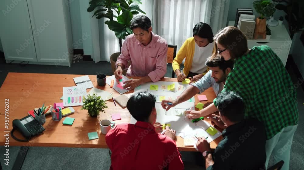 Poster close up of professional business team hands writing and putting sticky note on scrum task board. to
