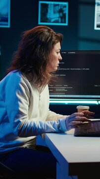 Vertical video Tired woman hurting from too much stress accumulated while doing software quality assurance on computer. Developer suffers from headache after inspecting coding on PC for too long