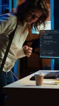 Vertical video Developer holding disposable cup of coffee entering office to implement security measures, protecting company systems and data. IT worker starting job shift, testing and debugging code