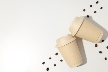 Paper cups with lids and coffee beans
