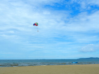 Parachute with blue sky. Famous extreme sport at the beach.