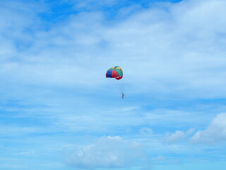 Parachute with blue sky. Famous extreme sport at the beach.