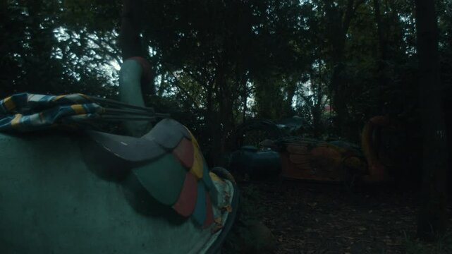 Abandoned Rides At The Amusement Theme Park Amidst Dense Trees. Close-up Shot