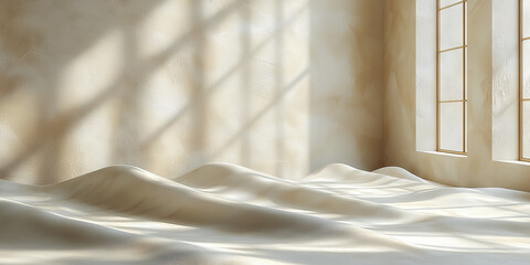 A minimalist room with a white fabric draped across the floor and sunlight streaming through the window.