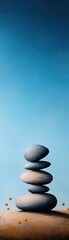 An artistic arrangement of smooth stones stacked on top of each other against a serene blue background, symbolizing balance and tranquility.
