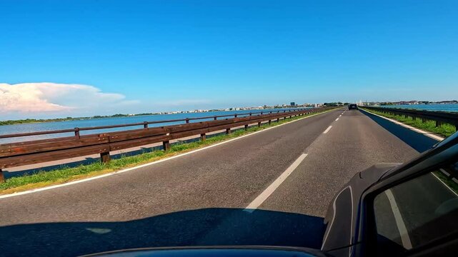 POV: on the road to Grado, Italy, in summer